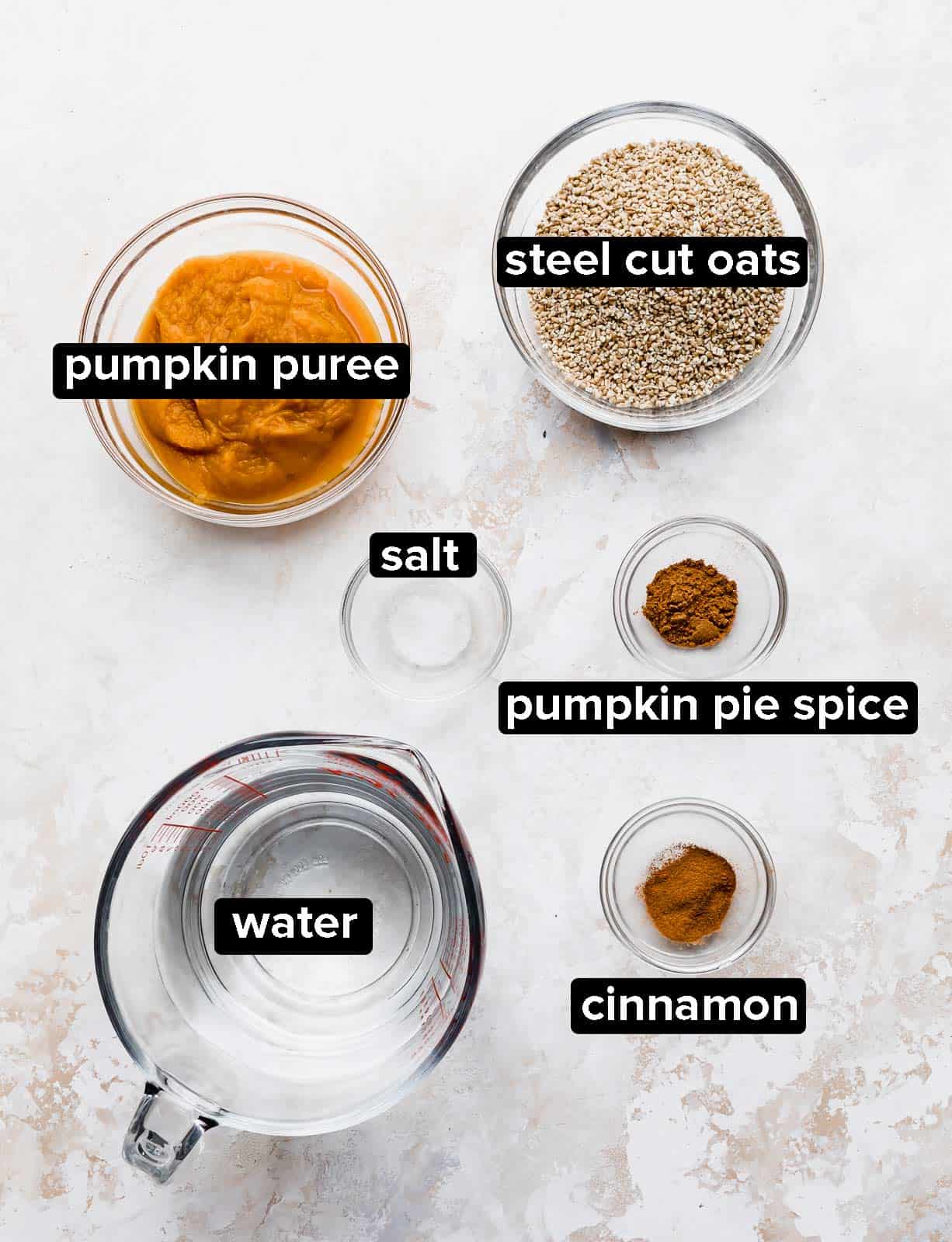 Pumpkin Steel Cut Oats ingredients on a textured white background.