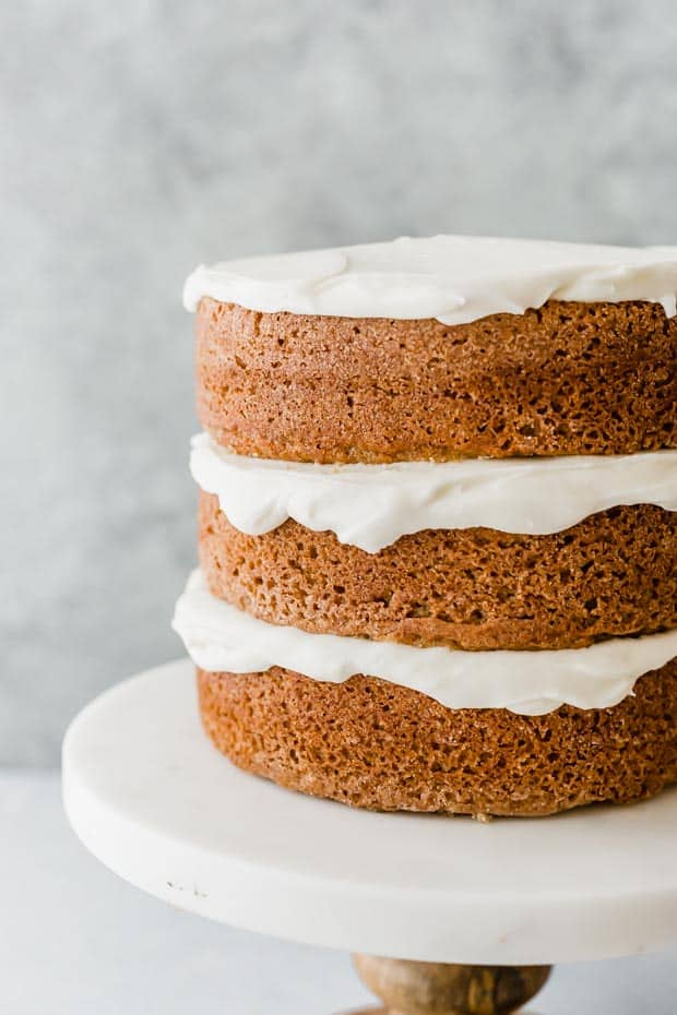Three layers of baked spice cake with cream cheese frosting between each layer.