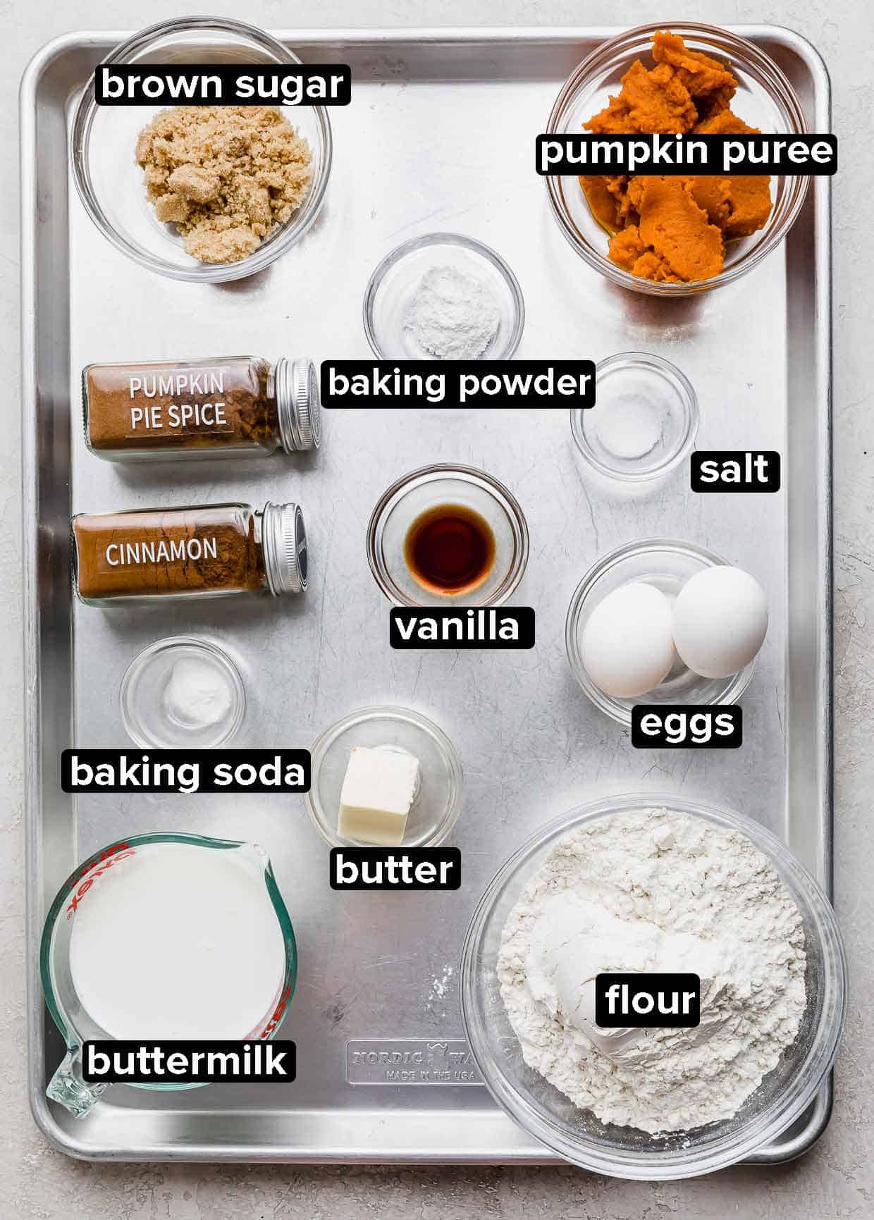 Pumpkin Pecan Pancake ingredients on a baking sheet, each ingredient in a separate glass bowl.