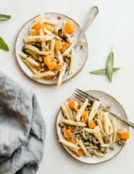 Two plates with the butternut squash pasta on each plate, with a fork along the side.