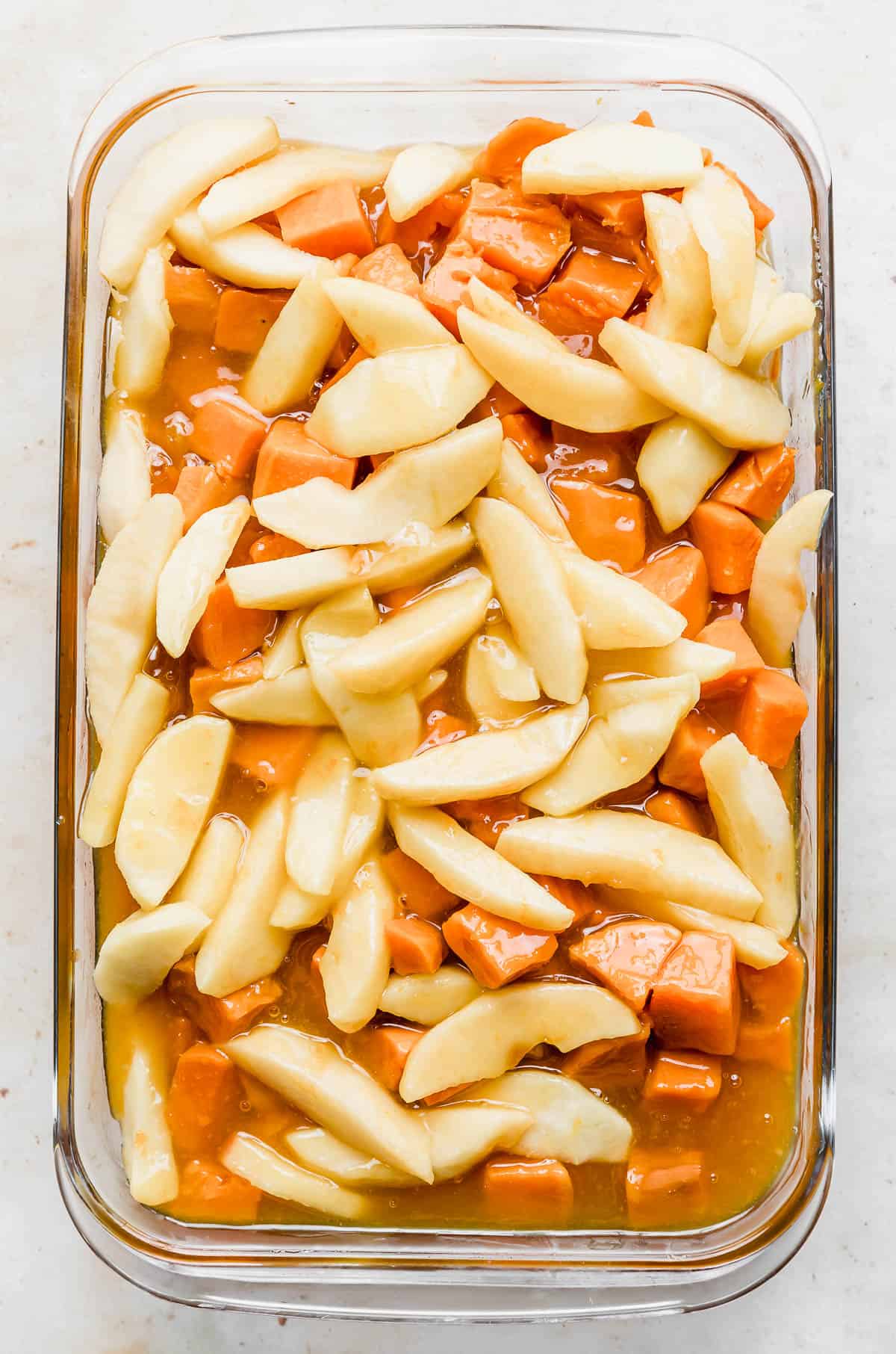 Candied Yams with Apples in a glass baking dish.