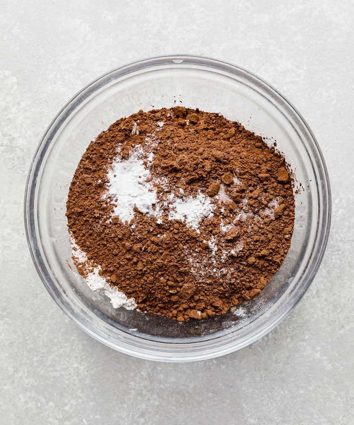 Flour, cocoa, and salt in a glass bowl.