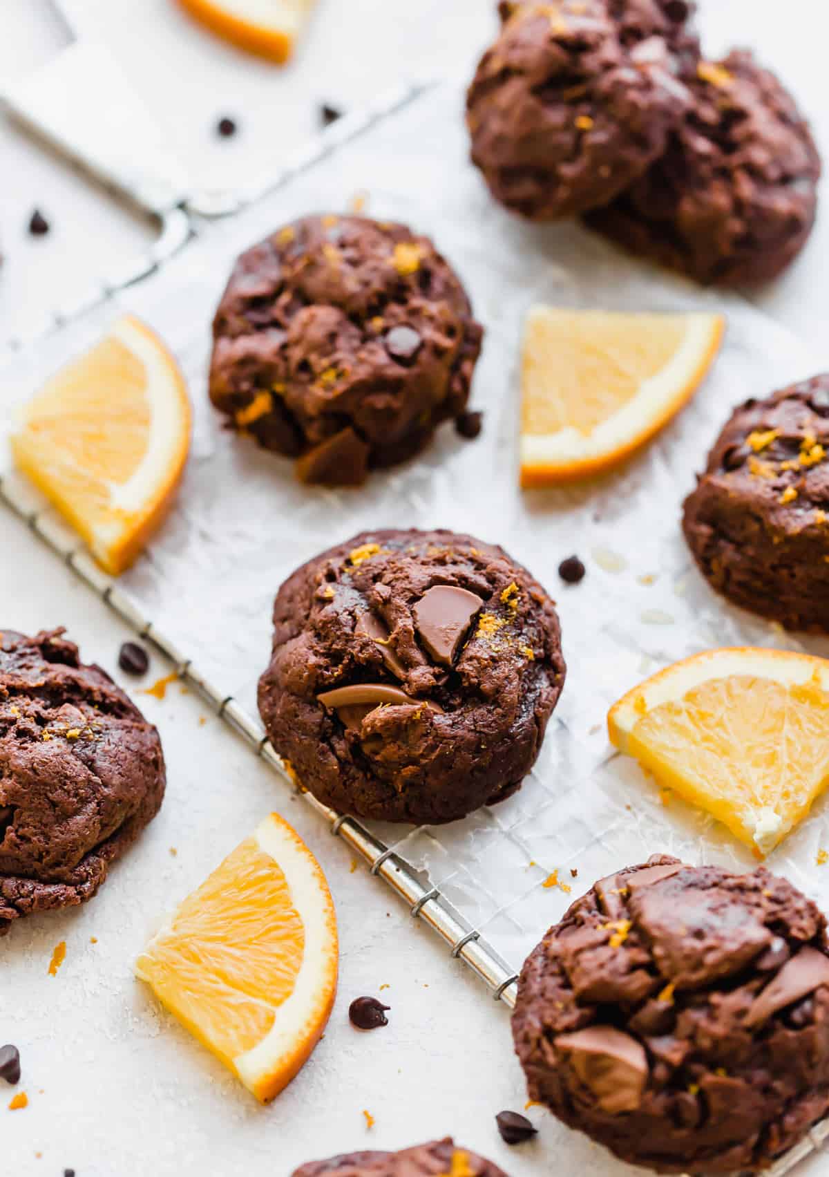 Chocolate Orange Cookies surrounded by fresh orange slices.
