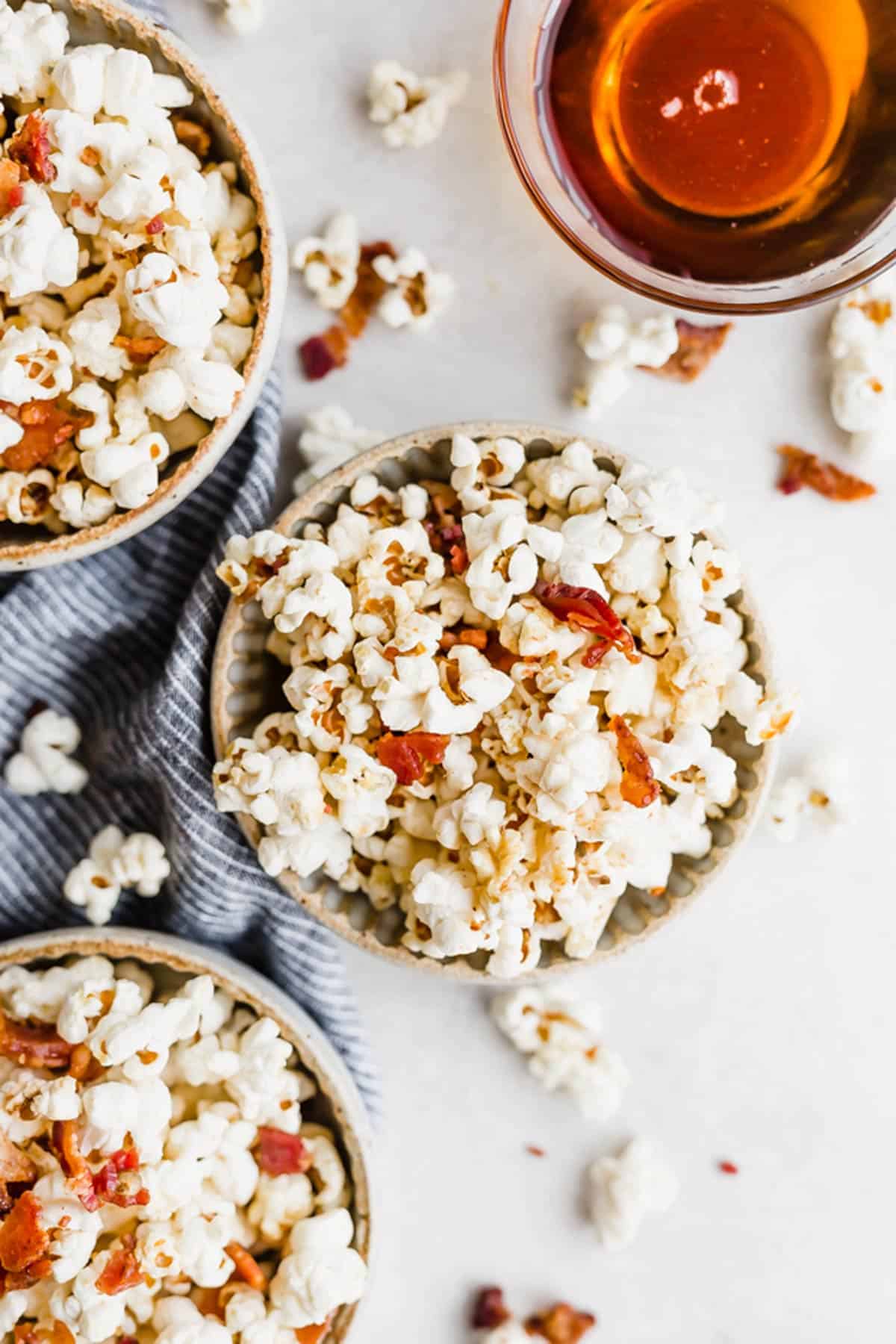 Maple Bacon Popcorn in three bowls, on a white background.