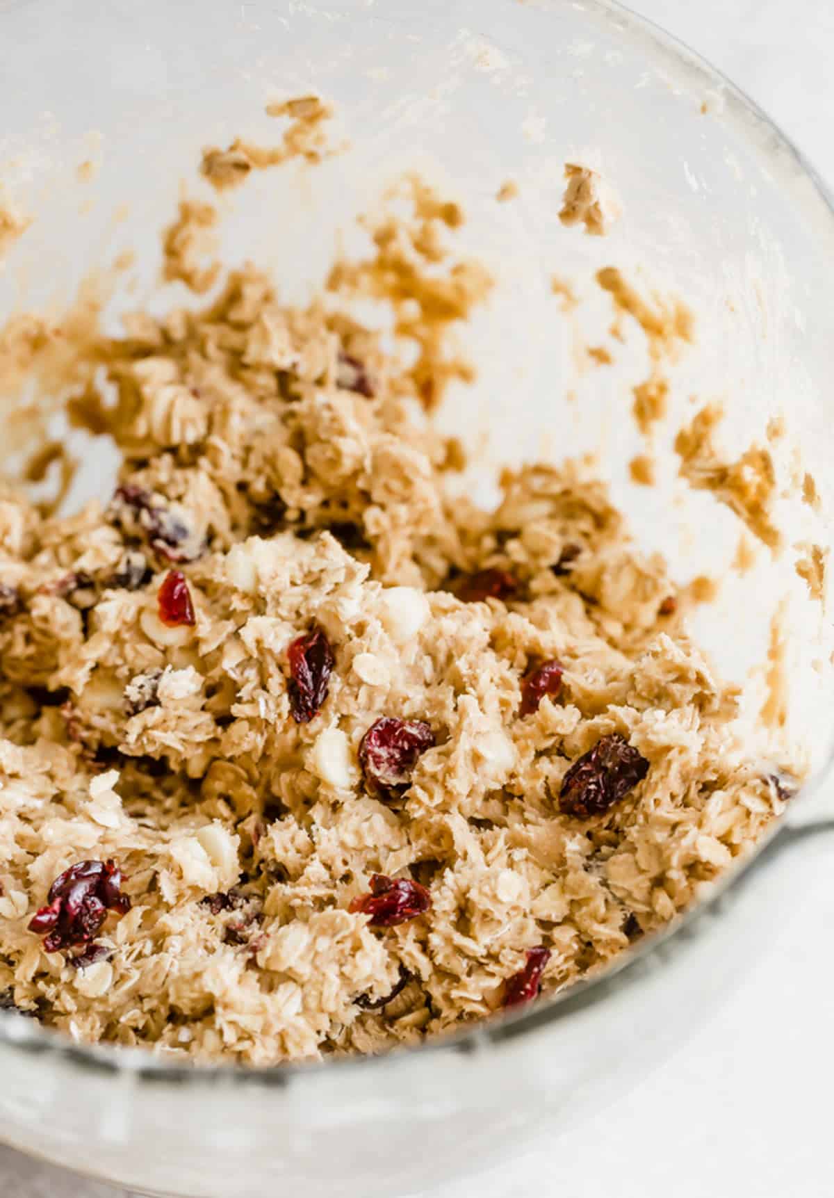 White Chocolate Cranberry Oatmeal Cookie dough batter in a glass bowl.