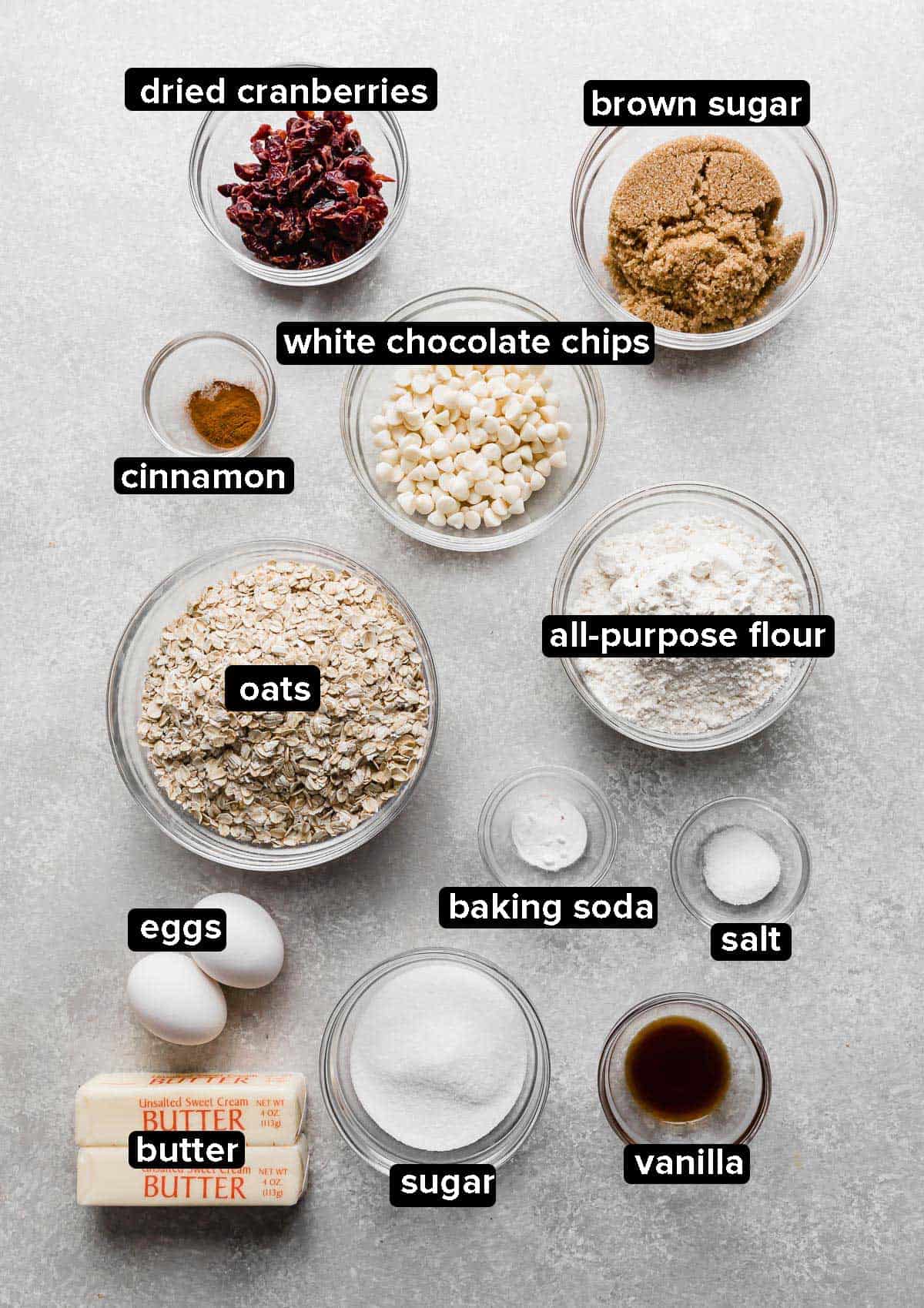White Chocolate Cranberry Oatmeal Cookies ingredients on a gray background.