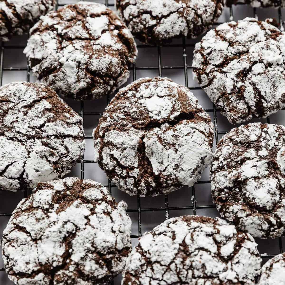 Chocolate Crinkle Cookies on a wire cooling rack.