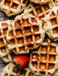Belgian Liege Waffles with a fresh strawberry next to the waffle.