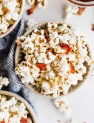 Maple Bacon Popcorn in a bowl on a white background.