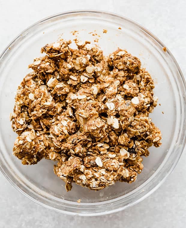 A glass bowl with mixed up oatmeal raising energy bites dough.