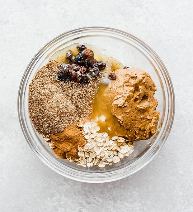 A glass bowl full of the ingredients to make oatmeal raising energy bites.