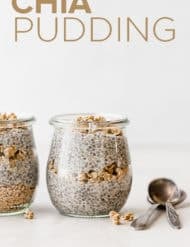 Two small glass jars with layers of granola and chia pudding.