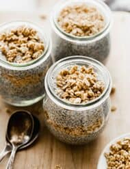 Three glass jars full of Keto chia pudding and topped with granola.