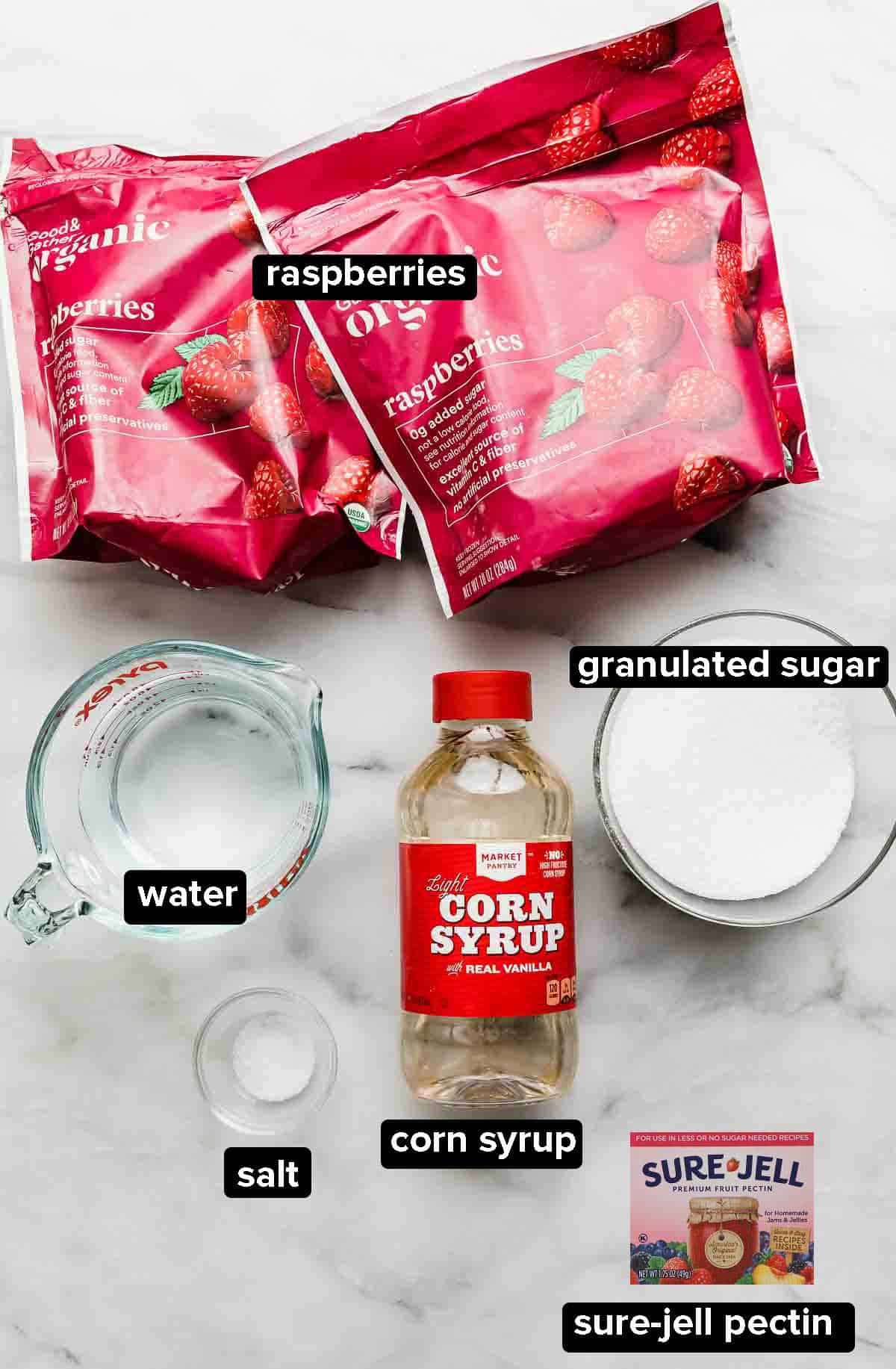 Raspberry Sorbet ingredients on a white background: pectin, corn syrup, sugar, salt, water, and frozen raspberries. 