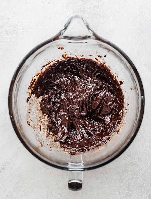 A glass bowl with brownie cookie batter.