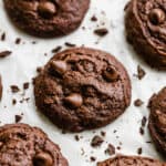 Brownie cookies loaded with chocolate chips surrounded by chocolate shavings.