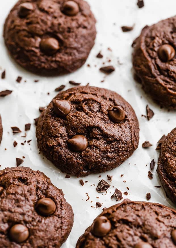 Brownie cookies loaded with chocolate chips surrounded by chocolate shavings.