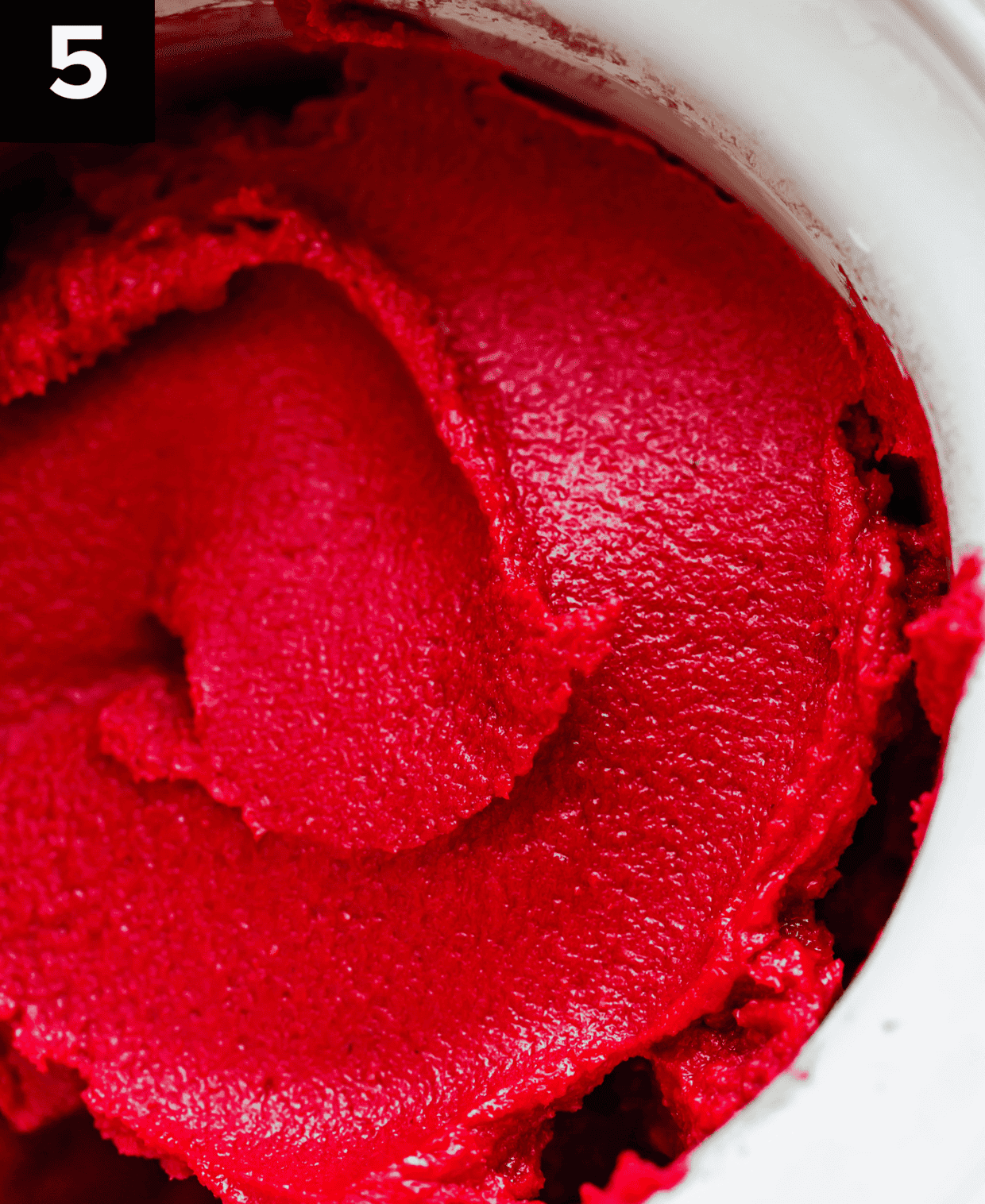 Raspberry Sorbet in an ice cream maker, having just finished churning.