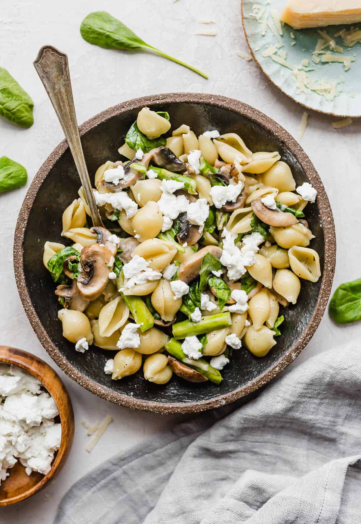 Fresh Asparagus Spinach Pasta in a black pasta bowl on a white background.