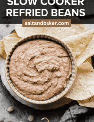 Crock pot refried beans in a tan bowl with the words, "Slow Cooker Refried Beans" written in white text over the top of the photo.