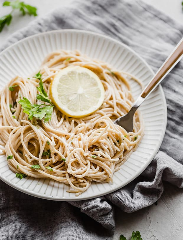 Lemon pasta twirled on a fork.