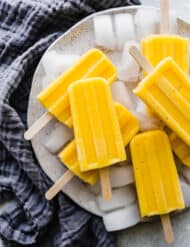 A pile of pineapple mango popsicles.