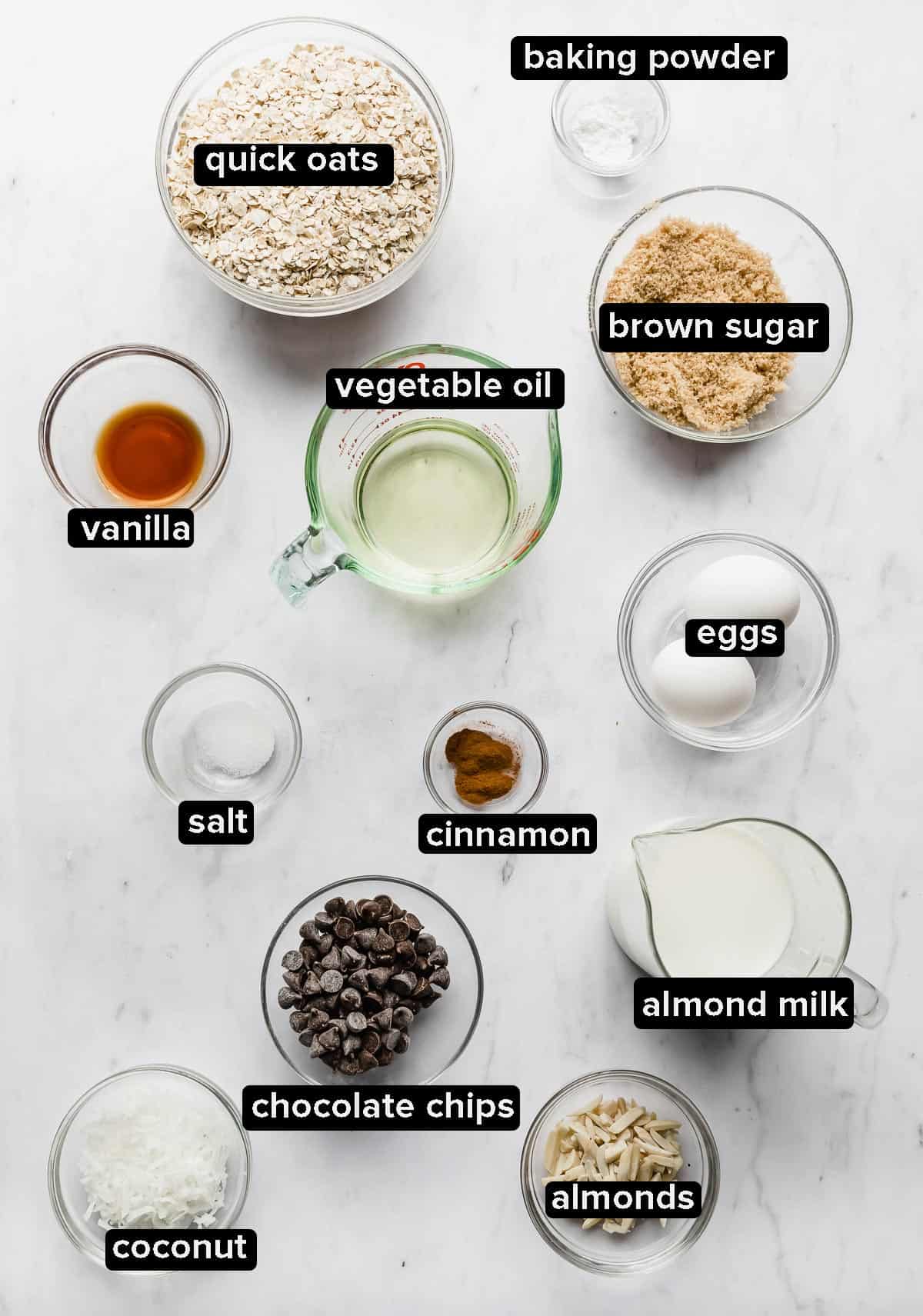 Ingredients used to make Baked Oatmeal Cups in glass bowls on a white background. 