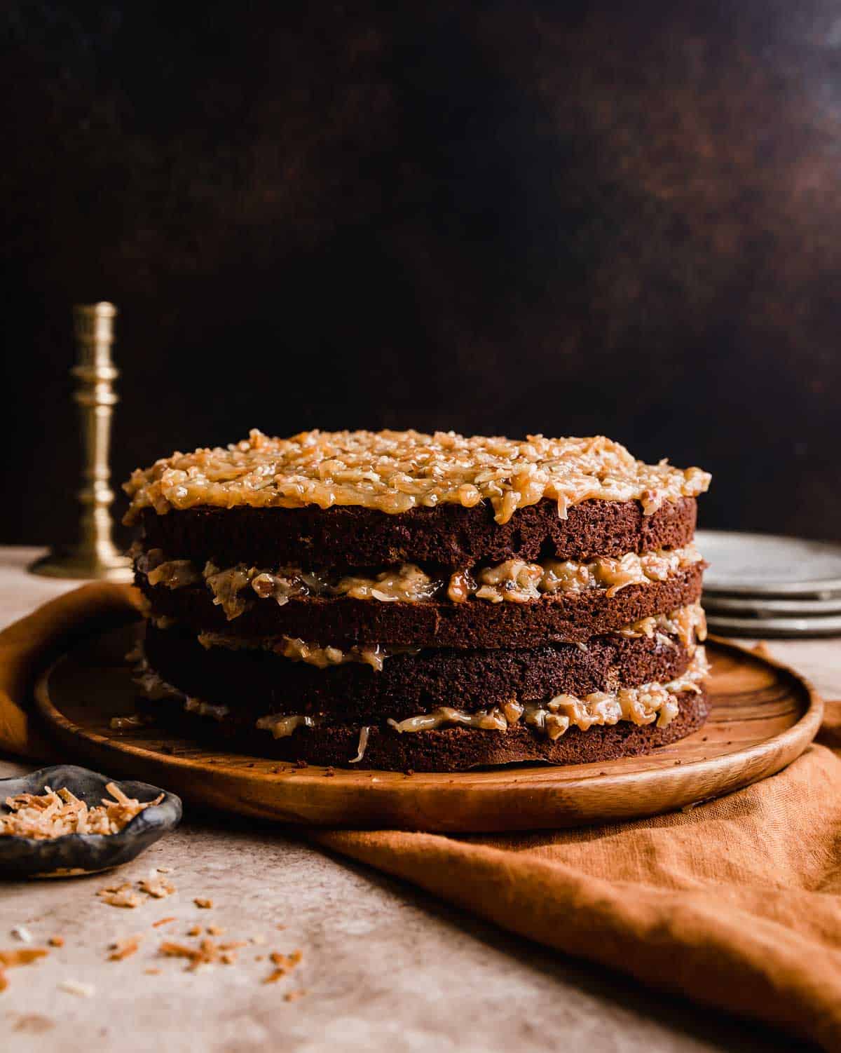 The best Traditional German Chocolate Cake recipe, four layers of chocolate cake with coconut pecan frosting between each layer, with no frosting on the sides. 