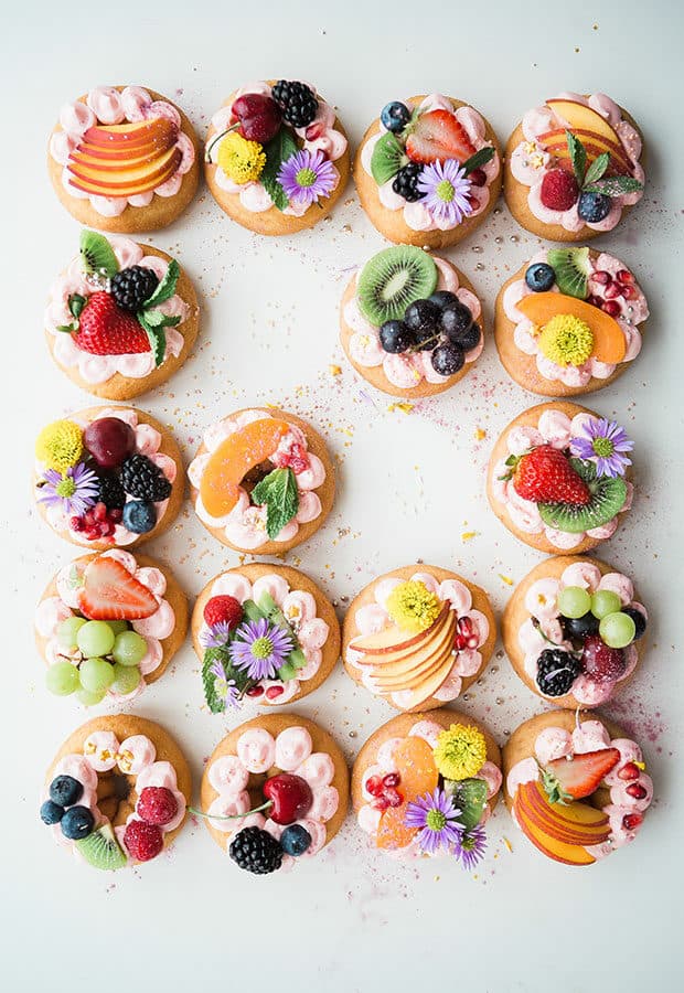 Donuts covered with fruits and flowers.