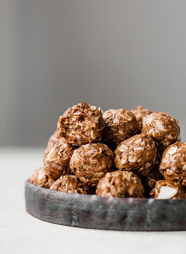 A plate with a stack of healthy almond joy energy bites.