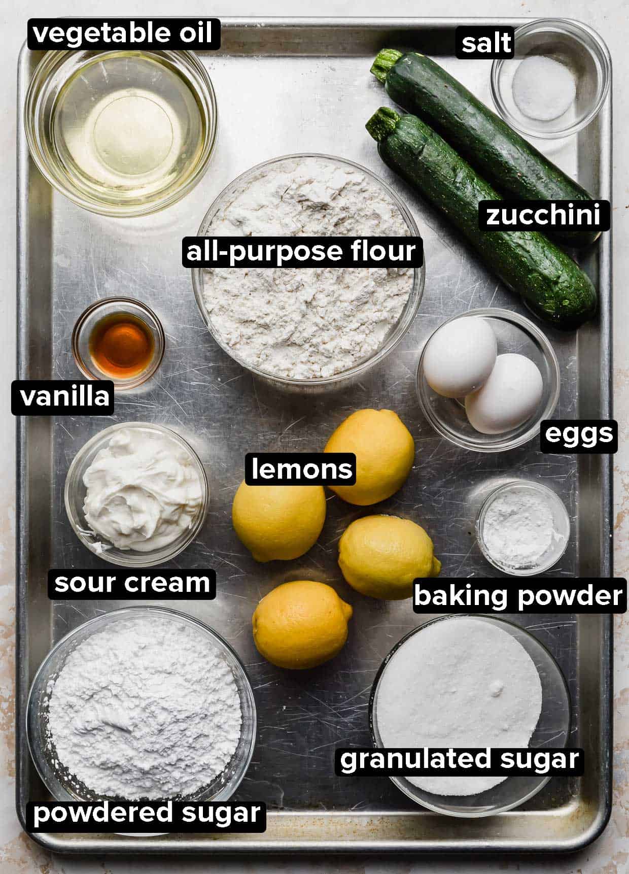 Lemon Zucchini Bread ingredients portioned on a baking sheet.