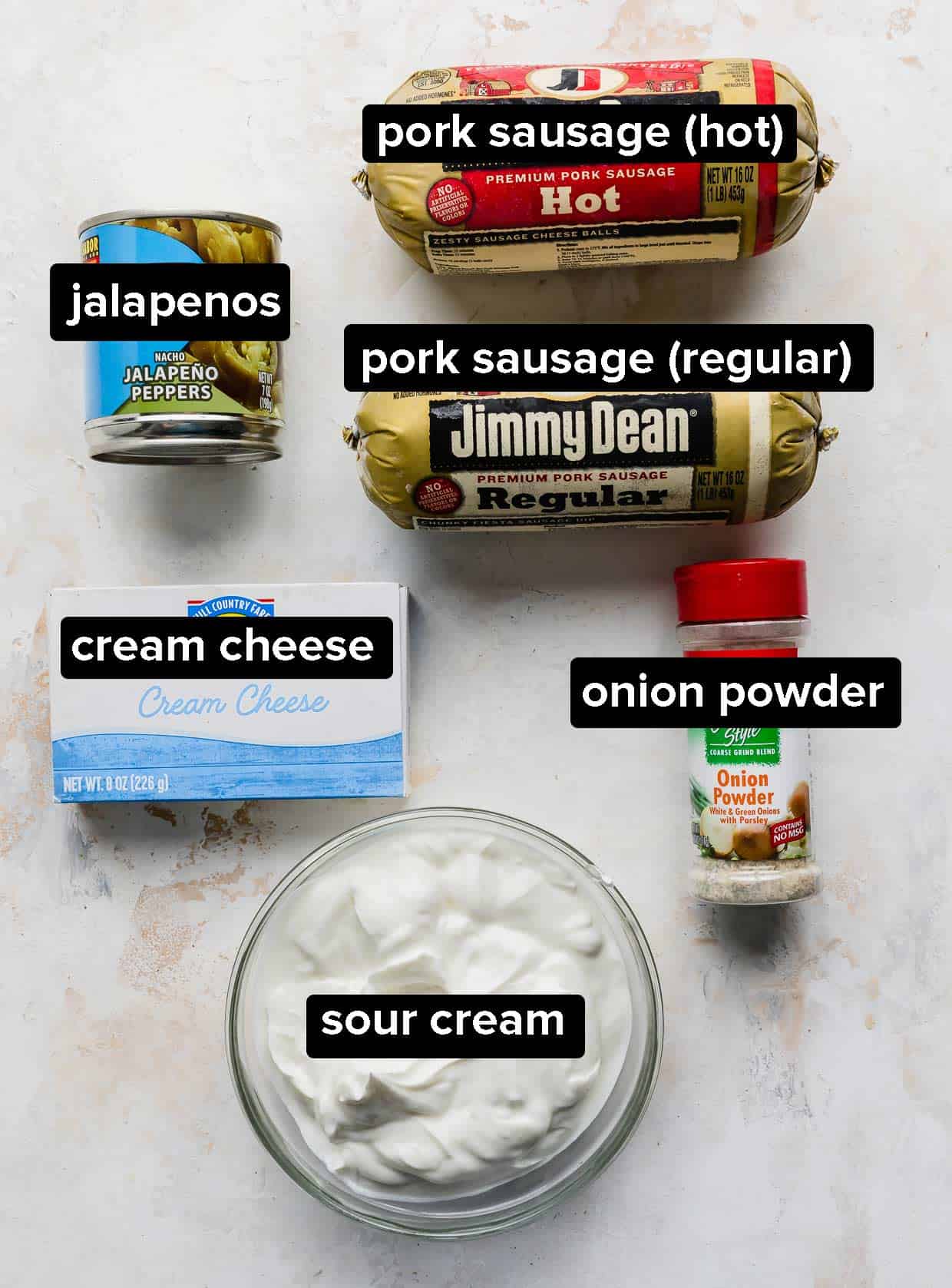 Ingredients used to make cream cheese sausage dip on a white background.