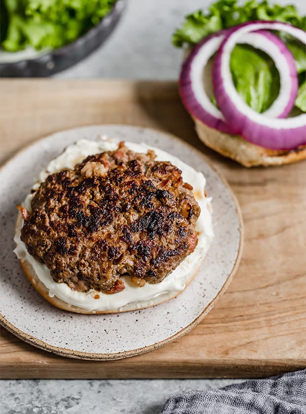 A bacon burger on a hamburger bun.