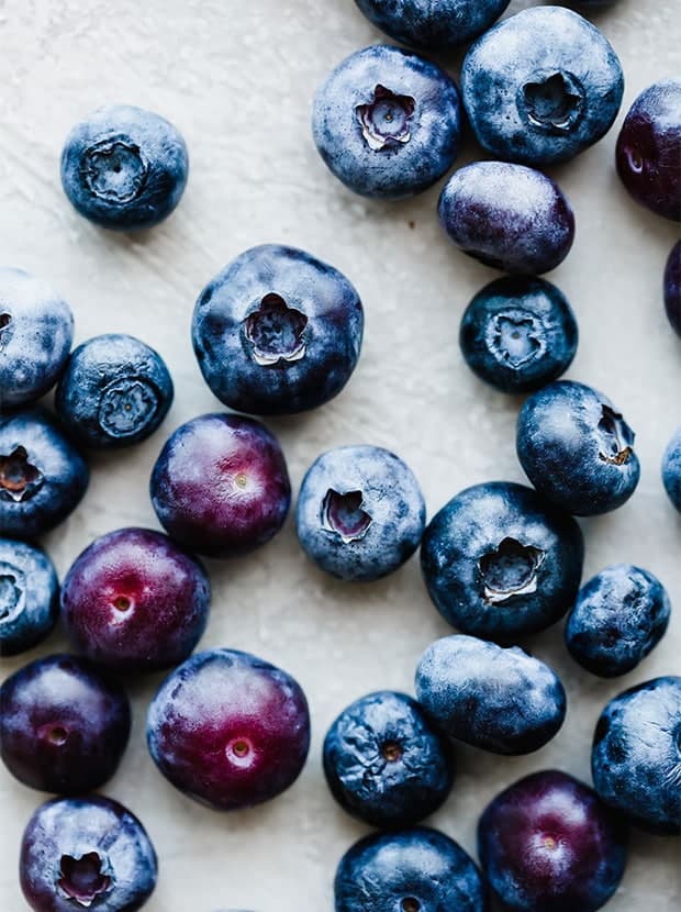 Blueberries scattered on a white background.