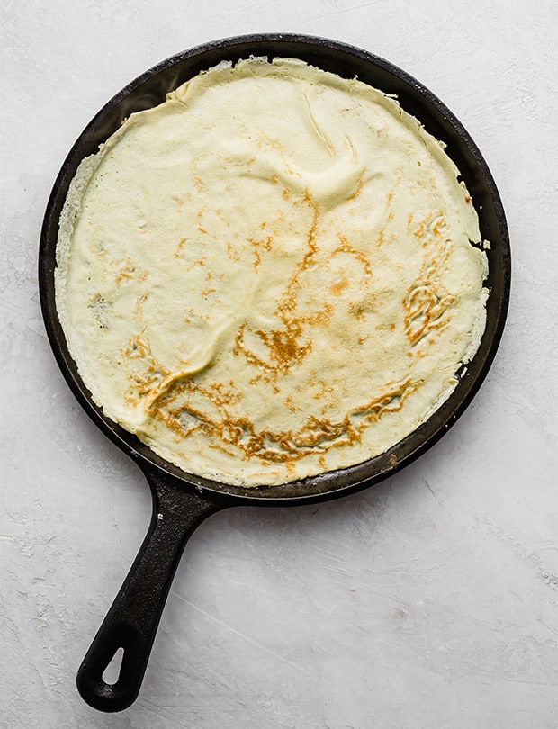 a cast iron skillet cooking an English pancake.