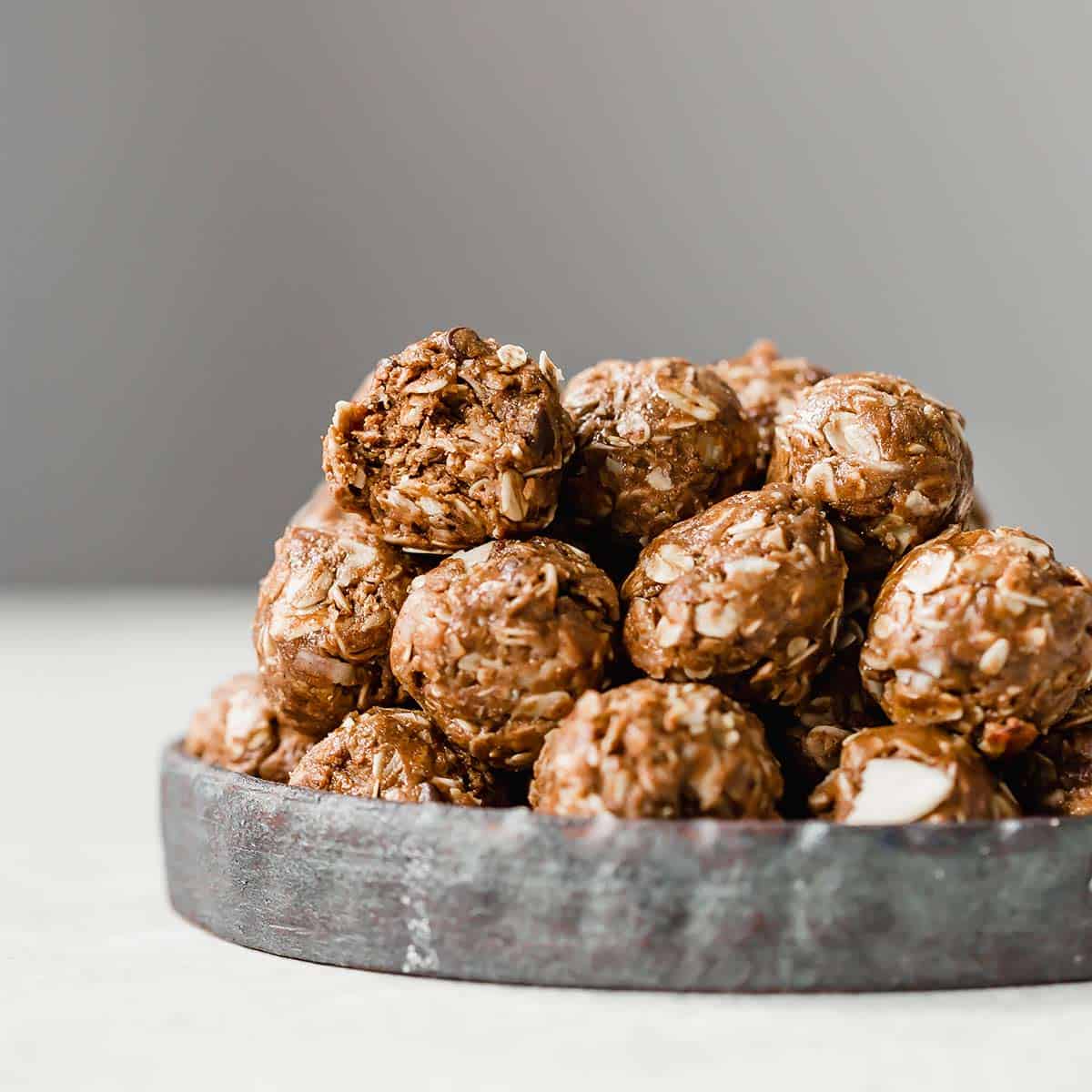 Almond Joy Protein Balls stacked on a round plate.