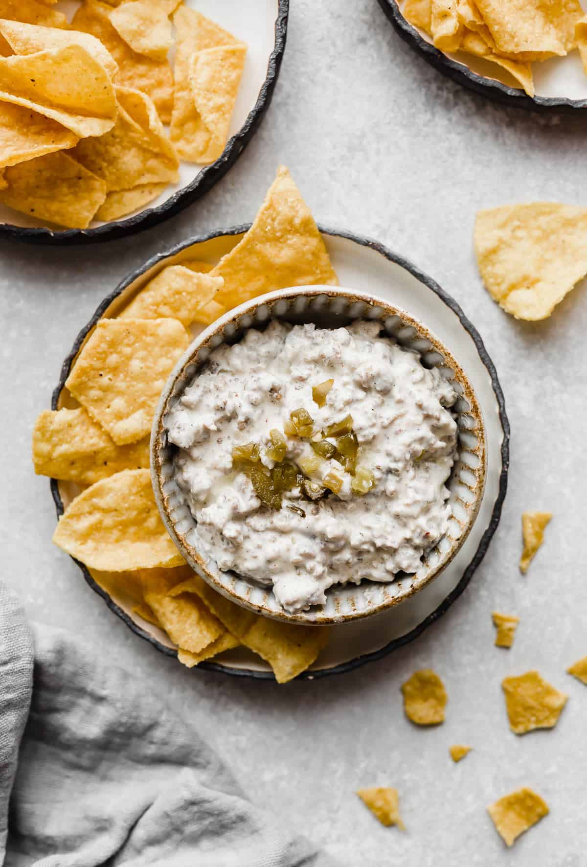 Cream Cheese Sausage Dip in a bowl surrounded by tortilla chips.