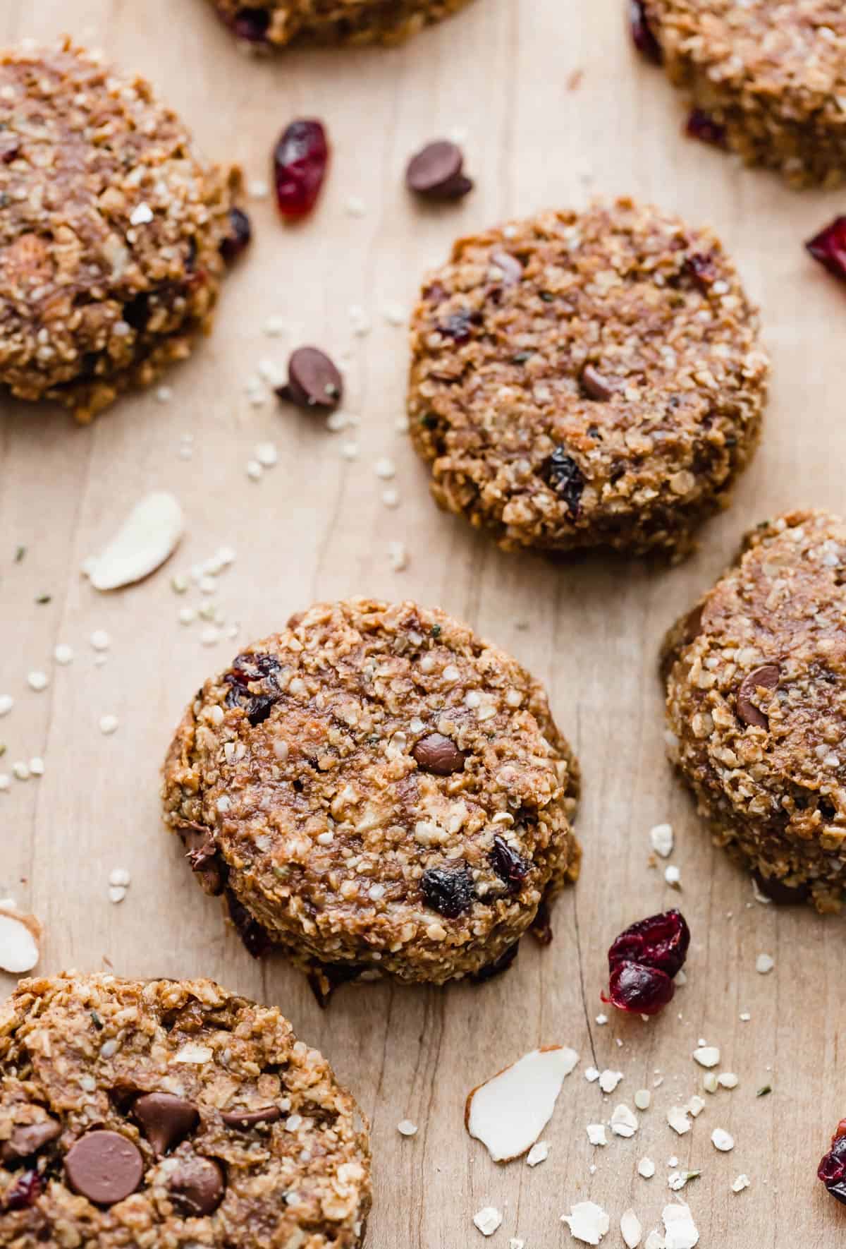 Breakfast Cookies studded with dried cranberries and nuts on a light brown background.