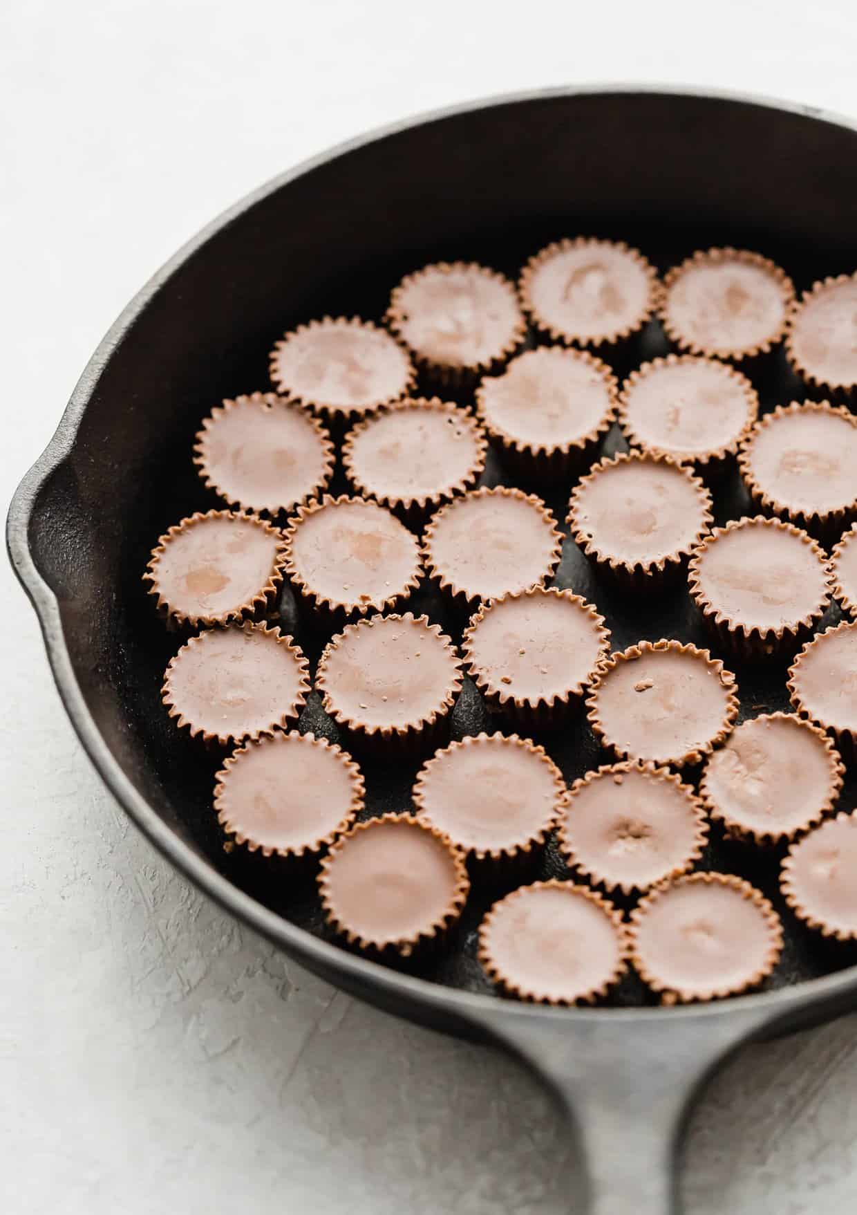 Reese's peanut butter cups in the bottom of a black skillet.