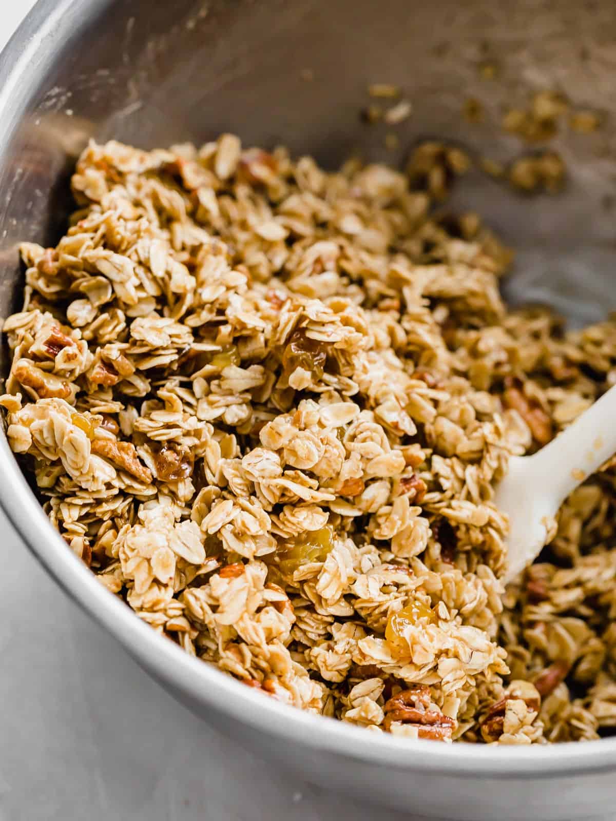 A silver bowl filled with an Oatmeal Raisin Granola Bars recipe mixture.