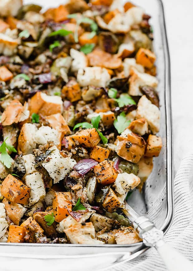 A casserole dish full of autumn vegetable stuffing.