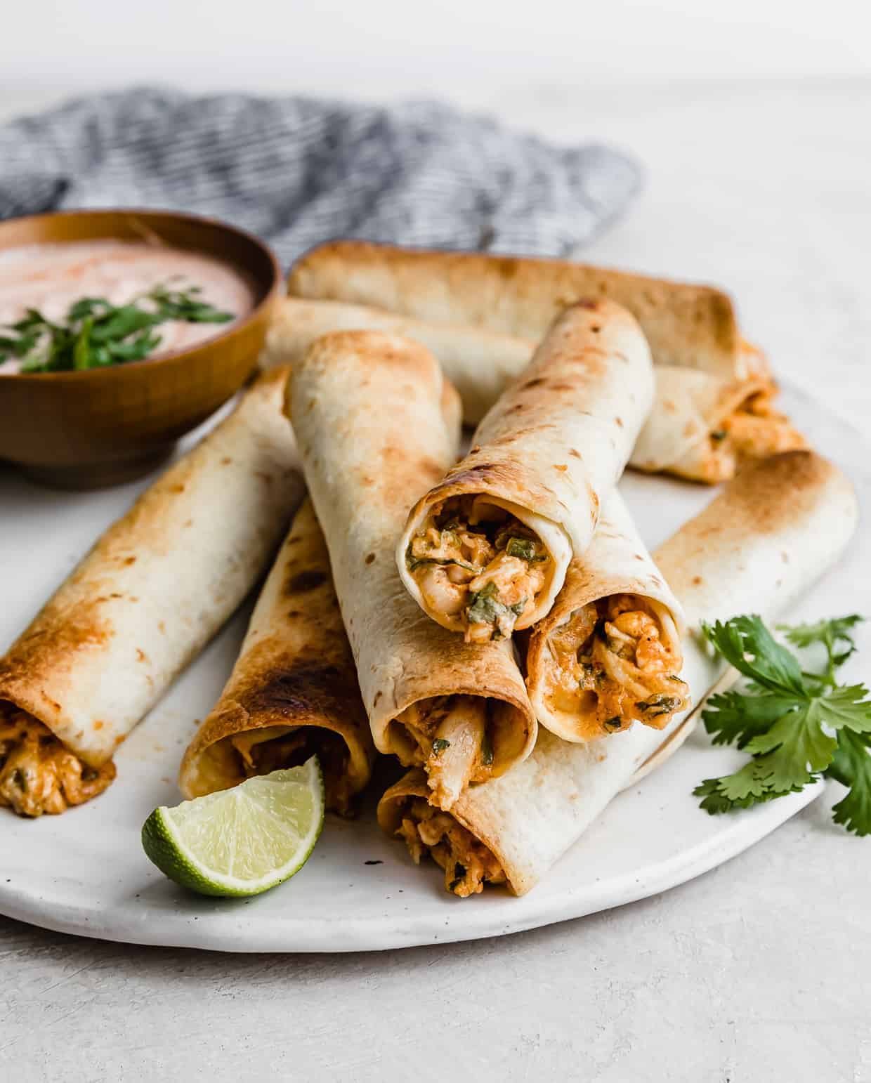 Crispy Baked Chicken Taquitos on a white plate.