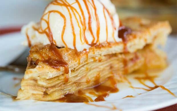 salted caramel apple pie with a scoop of ice cream on top.