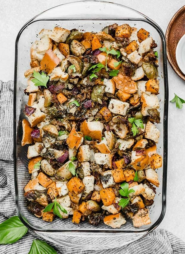 Baked autumn vegetable stuffing with sausage and veggies in a casserole dish.