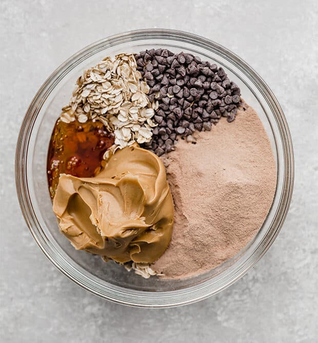 A bowl full of ingredients to make Chocolate Peanut Butter Protein Balls.