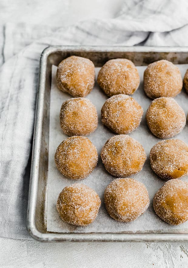 Gingerbread cookie dough balls rolled in granulated sugar.