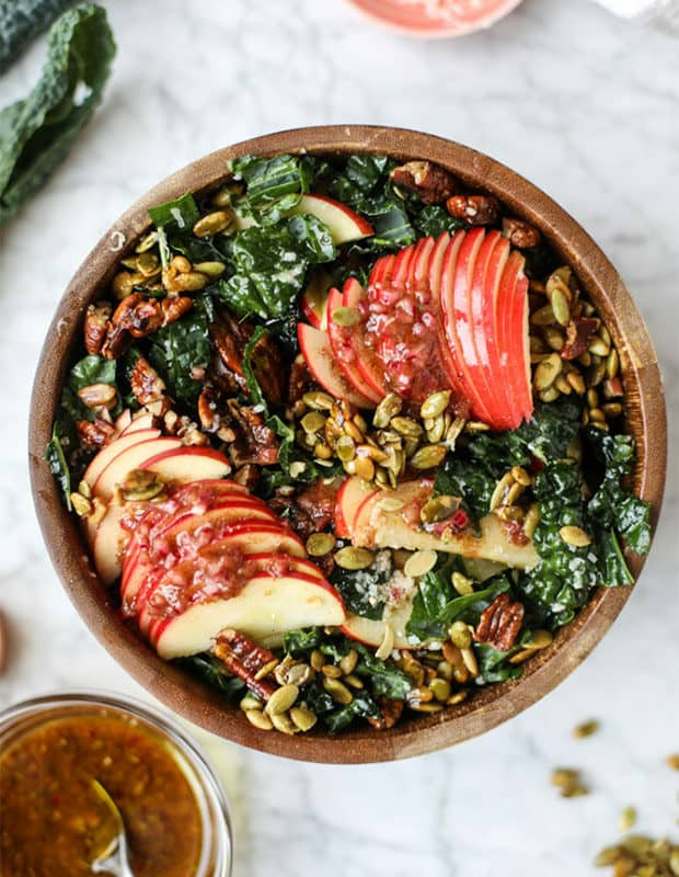 a kale salad with sliced apples.