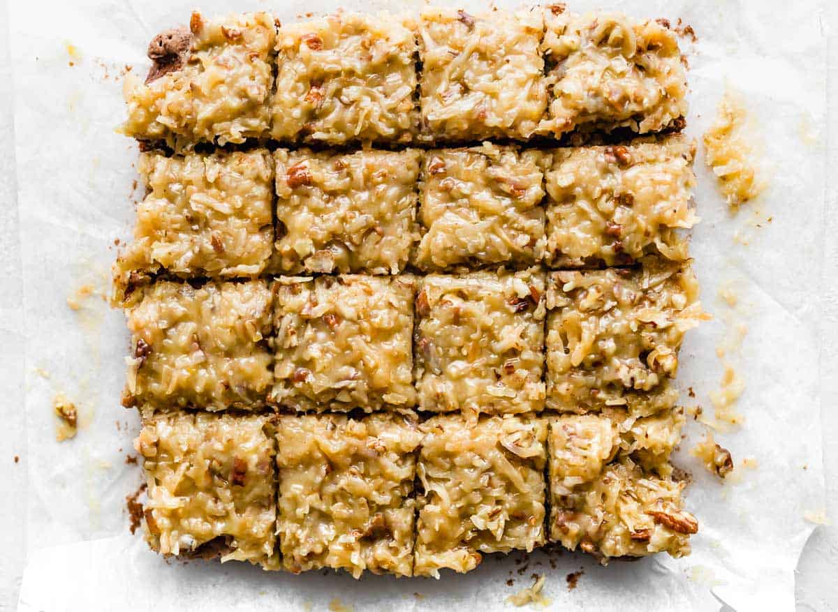 Coconut pecan frosting topped German Chocolate Brownies cut into 16 squares.