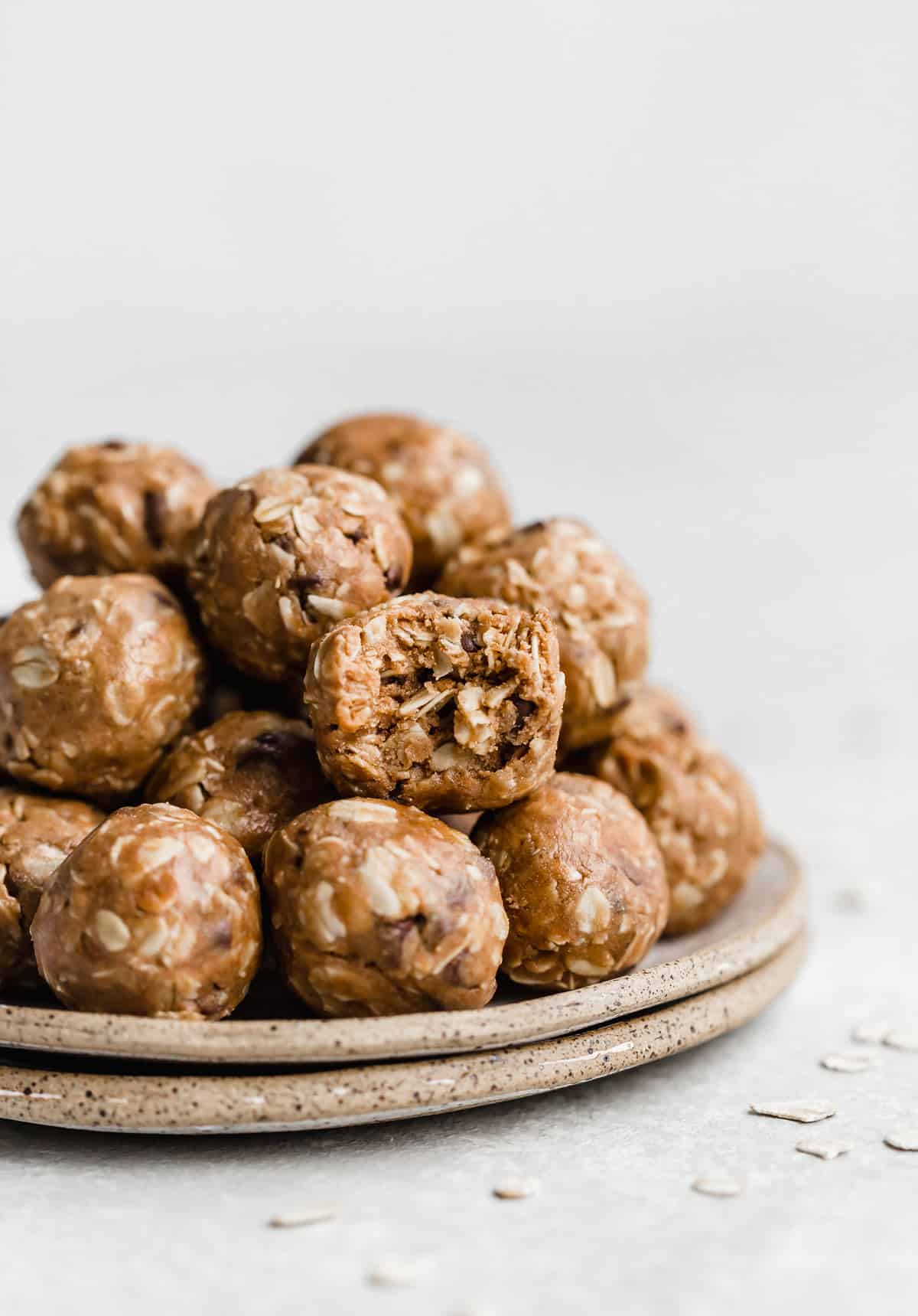 Chocolate Peanut Butter Protein Balls on a plate with one ball having a bite taken out of it.