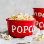 Movie Theater Popcorn in a red bowl with the word "popcorn" on the bowl.